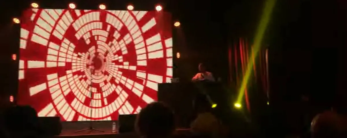 Radial pattern on an LED wall behind a performer