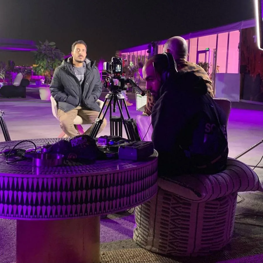 Interview being filmed on a lit outdoor set